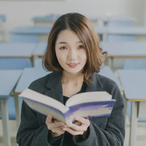 A woman studying Japanese with a book